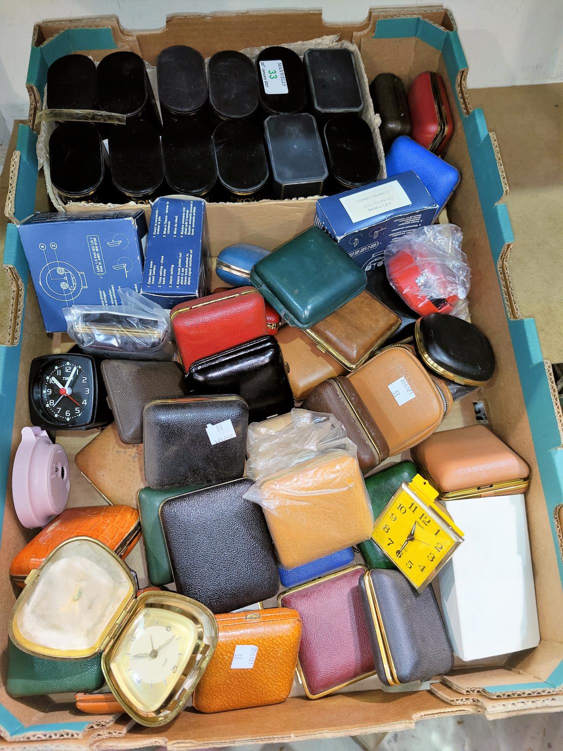 A large selection of unused travelling alarm clocks and Sekonda watches