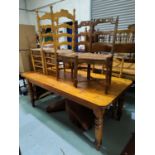Two 19th century French chairs with ladderbacks; A natural pine kitchen table carried on turned