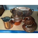 A 19th century large oval shallow pan; a 19th century copper kettle; a jug; 2 copper jelly moulds