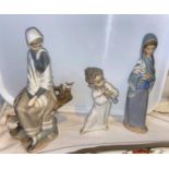 2 Lladro groups - seated girl with bird; boy with flute 25 & 26cm