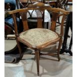 An Edwardian mahogany corner armchair with Sheraton inlay and embossed sage green seat, on shaped