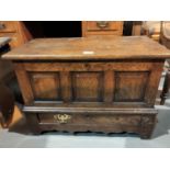 A Georgian style framed and panelled oak 'Coffer Bach' with hinged top, triple field front panels