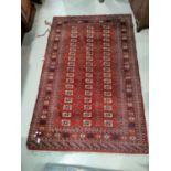 A modern hand knotted Bokhara rug with red ground, 198 x 126 cm (border fraying); a similar