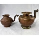 Two Indian copper pots with decorated spouts