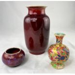 A Chinese ox blood glaze vase with flared rim, height 22cm, drill hole to base; a small Chinese bowl