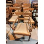 A Regency mahogany set of 7 (5 + 2) dining chairs on turned legs, with brown fabric drop in seats