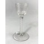 An 18th century opaque twist wine with wheel turned ogee bowl