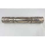 An Indian white metal scroll tube with decoration in relief and with presentation inscription to the