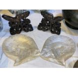 A pair of Chinese mother of pearl finely carved shells on stands with carved hardwood bases,