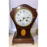 An Edwardian mantel clock in mahogany balloon shaped Sheraton inlaid case, with white enamel dial