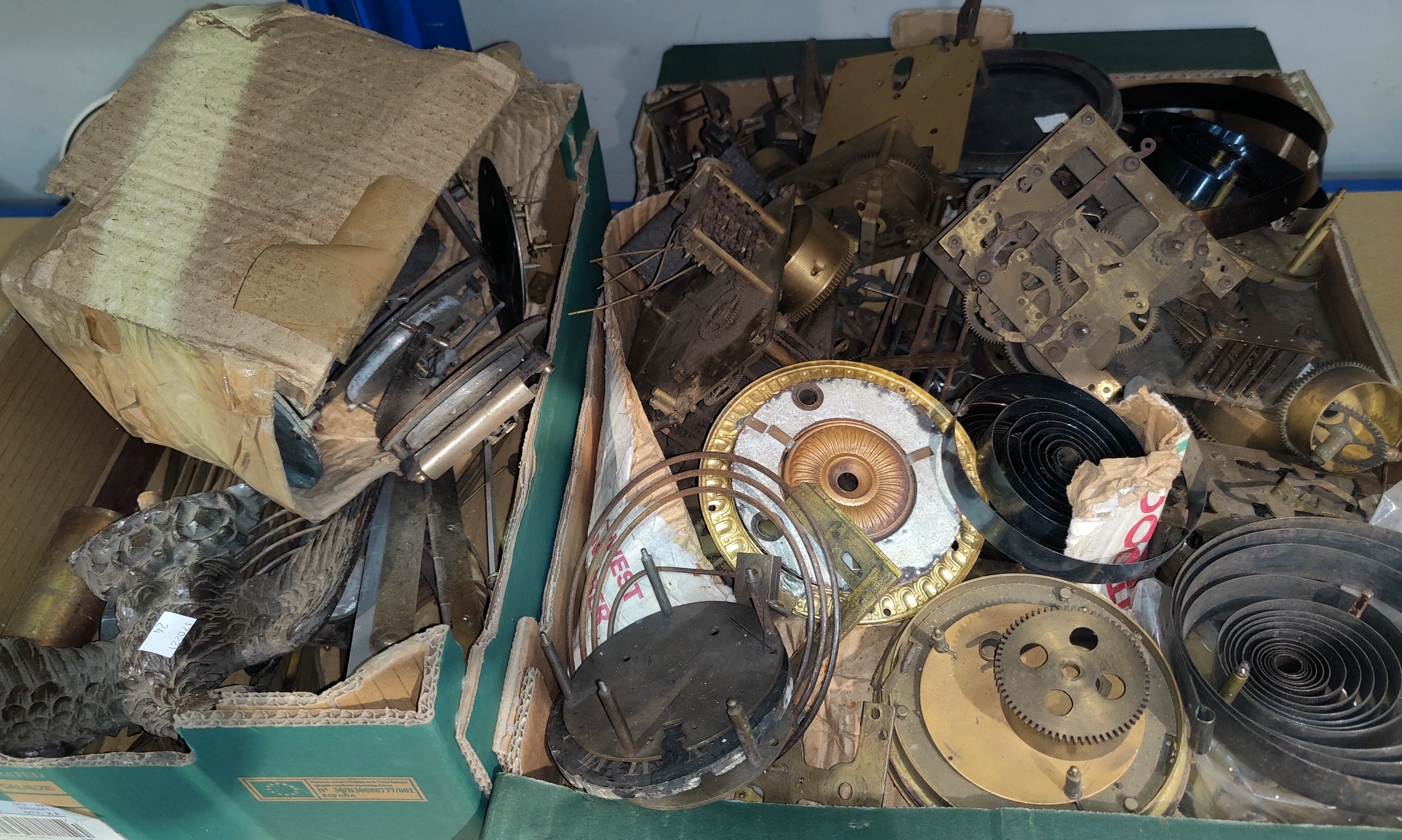 A selection of old clock parts; movements; springs; etc.