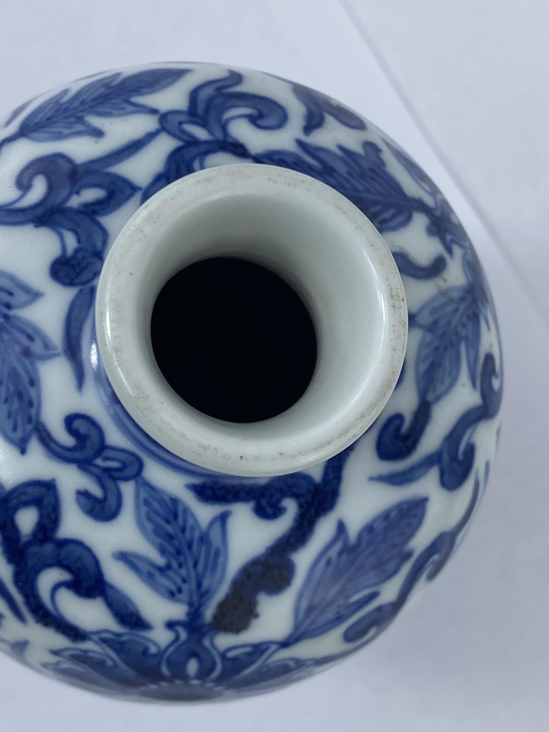 A Chinese blue and white vase with floral decoration with double circle mark to base, height 19cm - Image 2 of 3