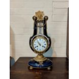 A Louis XVI style mantel clock in ormolu and porcelain lyre shaped case, with ornate mounts and