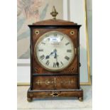 A Georgian bracket clock in caddy top walnut case with ornate pineapple finial, ornate ring handles,
