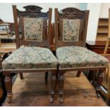 An Edwardian set of 6 oak dining chairs in floral tapestry