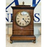 A late Georgian bracket clock in rosewood case with brass finial, ring handles and ball feet,