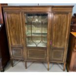 An Edwardian inlaid mahogany display cabinet in the Sheraton style with central glazed and 2