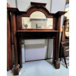 An early 20th century mahogany fire surround with mirror back and turned side columns, height 200