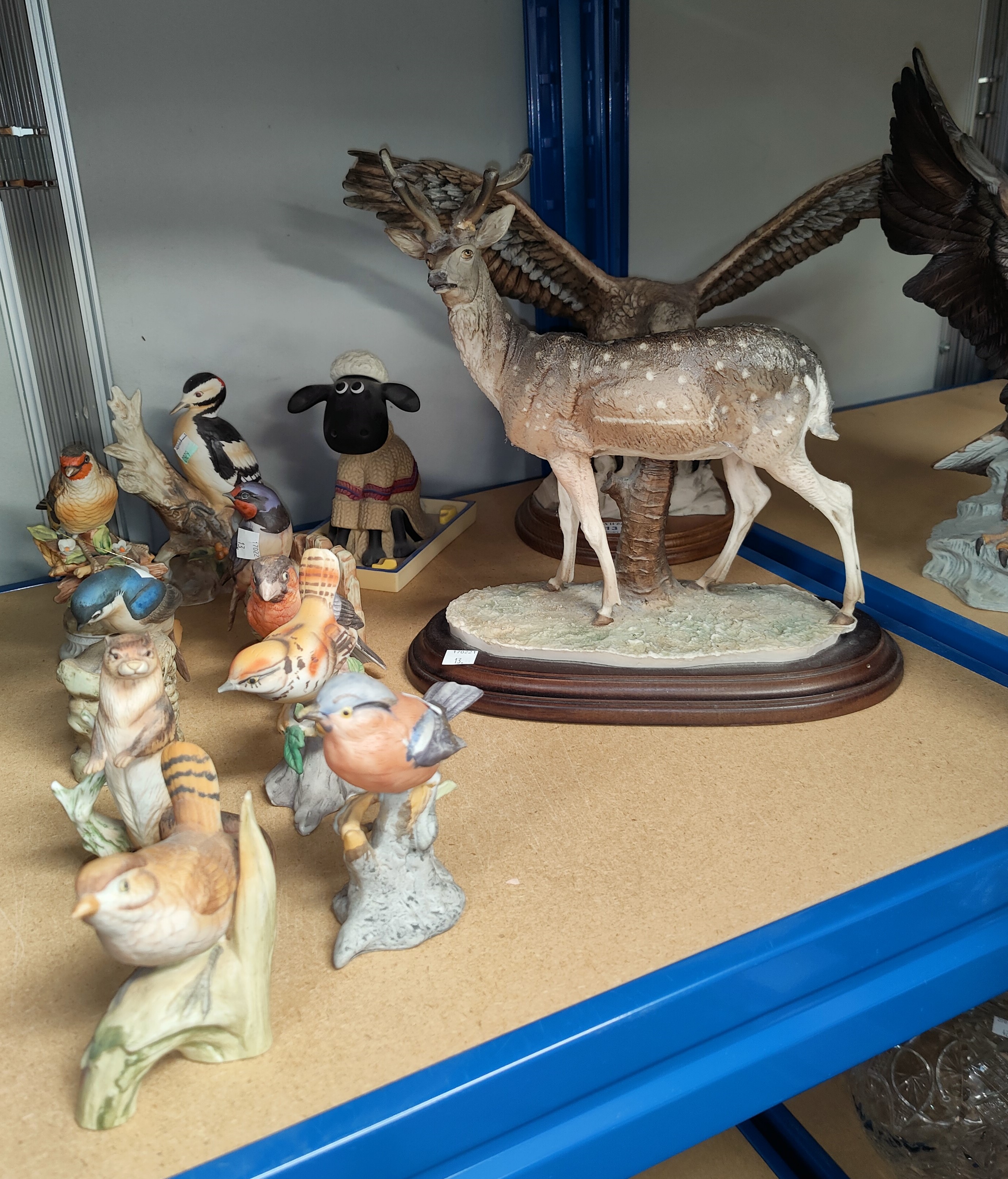 A resin deer and eagle; a selection of bisque animals and birds