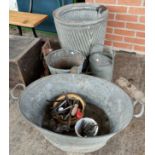 A metal dolly tub and vintage garden equipment