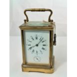 A late 19th/early 20th century brass carriage clock with white enamel dial and timepiece movement