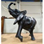 A large ebonised wooden carved figure of an elephant height 57cm