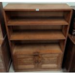 An oak Arts & Crafts style bookcase with double cupboard to base