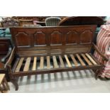 A late 18th/early 19th century oak settle with panel back on cabriole front legs(later slats) length