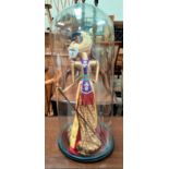 A Far Eastern glass puppet under glass dome, approx 66cm height