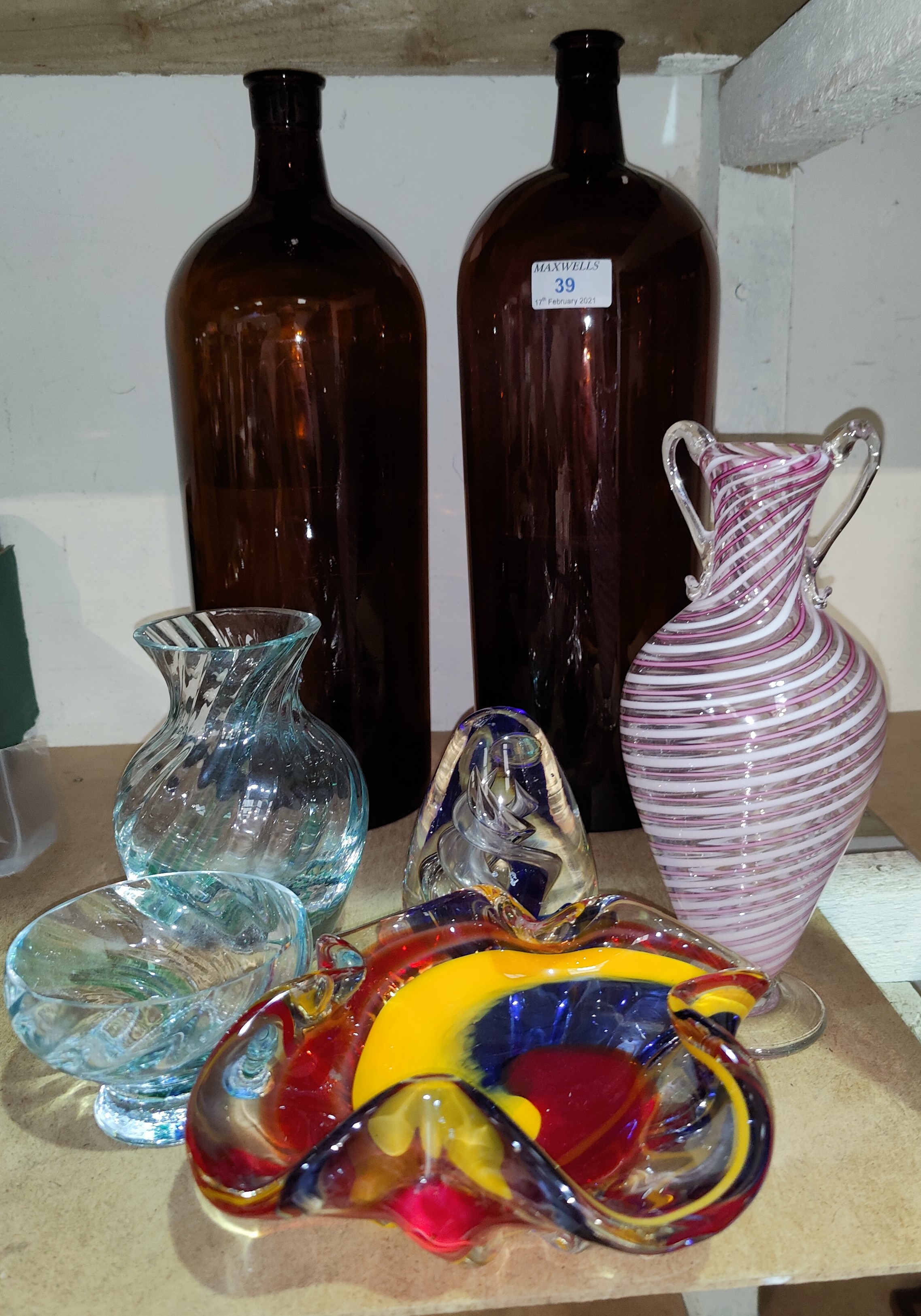 Two amber glass chemist style bottles, ht 40 and 37cm, other coloured glassware