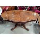 A 19th century shaped oval burr walnut loo / dining table on carved and turned baluster column and