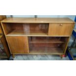 A 1960's Nathan pale oak bookcase fitted drop flap desk and cupboard, sliding glass doors, 122 cm
