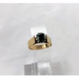 A 1970's yellow metal dress ring with wide shank and shoulders, set green topaz type stone, 9ct, 3.4