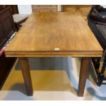 A 1930's golden oak dining table with rectangular draw leaf top, on square legs, length 122