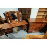 A near matching bedroom suite comprising kneehole dressing table, mirror, chair and 3 height chest