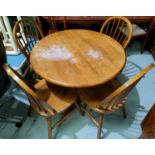 A breakfast set comprising circular pedestal table and 4 hoop back chairs