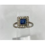 A white metal square dress ring set central cushion cut sapphire surrounded by 16 diamonds, length