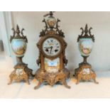 A 19th century French 3 piece clock garniture in ornate gilt metal and porcelain decorated with