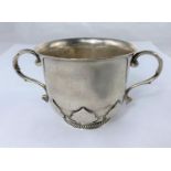 A porringer with relief decoration to lower body and circular gadrooned foot, Birmingham 1921, 9.