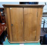 A pine refectory style table; a pine corner cupboard