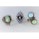 A 1960's/70's modernist yellow metal dress ring with elliptical opal coloured stone and small blue