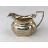 A Georgian style silver cream jug, 3.4oz, Birmingham, 1904