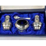 A modern silver three piece cruet set, boxed