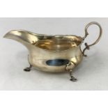 A Georgian style silver sauce boat, C scroll handle, hoof feet, 4.1oz, Sheffield 1912