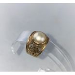 A large pearl set dress ring with extensively pierced shoulders, stamped '9ct', size R-S, 6.5 gm