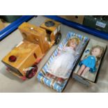 A ride-along toy engine and two 1960's dolls