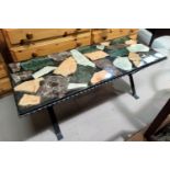 A 1960's wrought iron coffee table with coloured marble effect top