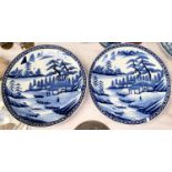 A pair of large Japanese blue and white chargers with traditional country scenes, diameter 146cm