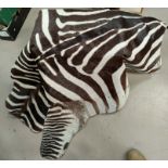 A zebra skin rug/throw mounted on a black material with weights on the inside, length 184cm