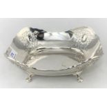 A silver bread dish with pierced decoration, carried on four paw feet, 12.4oz maker HA Sheffield,